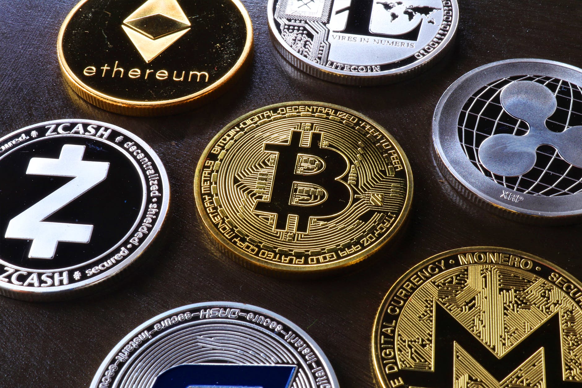 various cryptocurrency Bitcoin coin on table